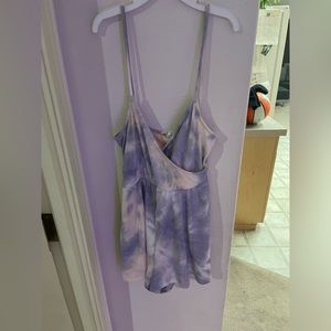 Purple, White and slight Pink Romper Size extra small.